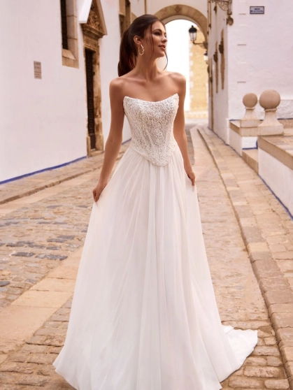 Love by Enzoani FENORA-A is a versatile two-piece designer wedding dress featuring an intricately embellished lace corset bodice paired with a lightweight chiffon A-line skirt. Combining modern bridal fashion with timeless romance, this luxury wedding gown