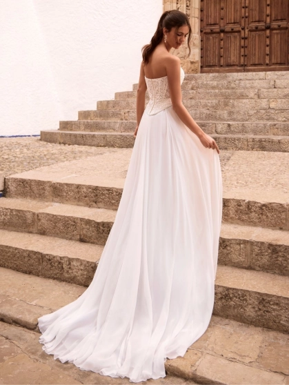 Love by Enzoani FENORA-A is a versatile two-piece designer wedding dress featuring an intricately embellished lace corset bodice paired with a lightweight chiffon A-line skirt. Combining modern bridal fashion with timeless romance, this luxury wedding gown